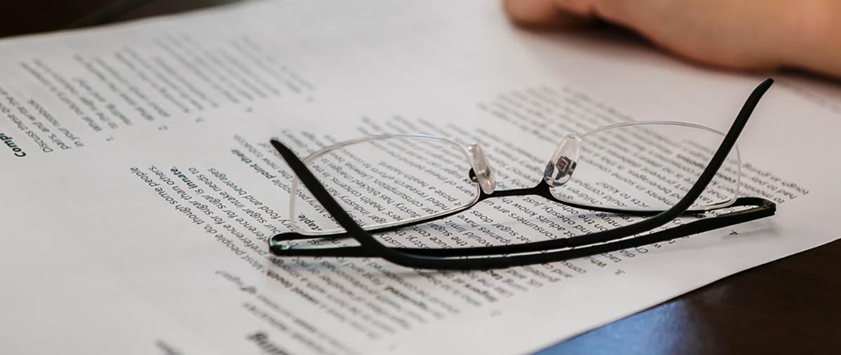 Pair of glasses on document