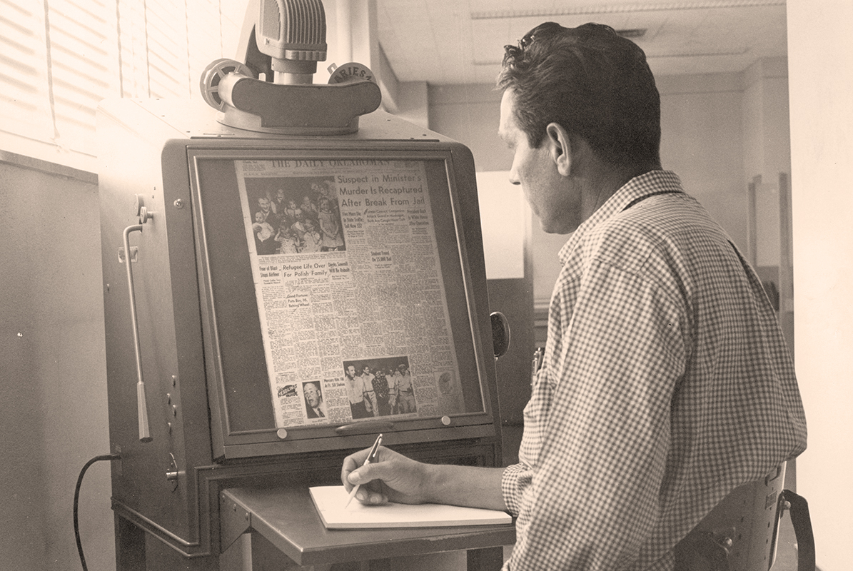 A person reading microfilm