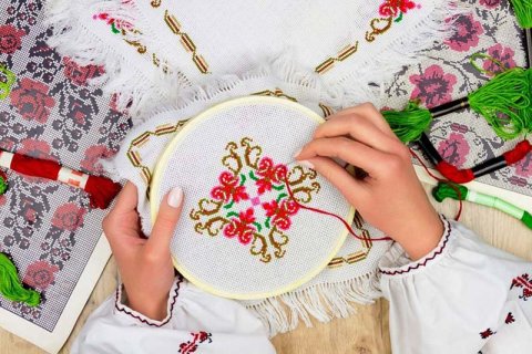 Hands making embroidery, from https://authenticukraine.com.ua/en/traditions-crafts