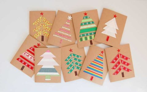 Two rows of stacked brown cards with colorful decorative tape designed into Christmas trees. 