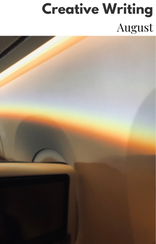 Image of colorful rainbow light shining against the wall of an airplane. 