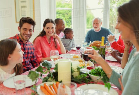 multi ethnic, multi generational family at dinner