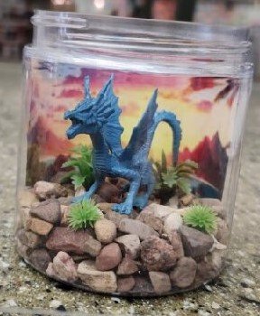 Plastic dragon in a decorated jar