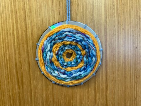 Create a circular weave using a repurposed CD.