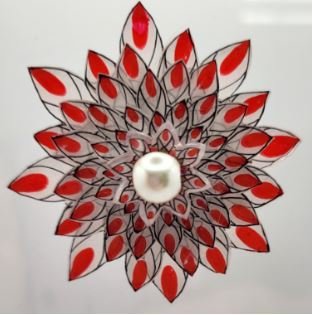 Red Brooch with Pointed Petals surrounding a centered bead.