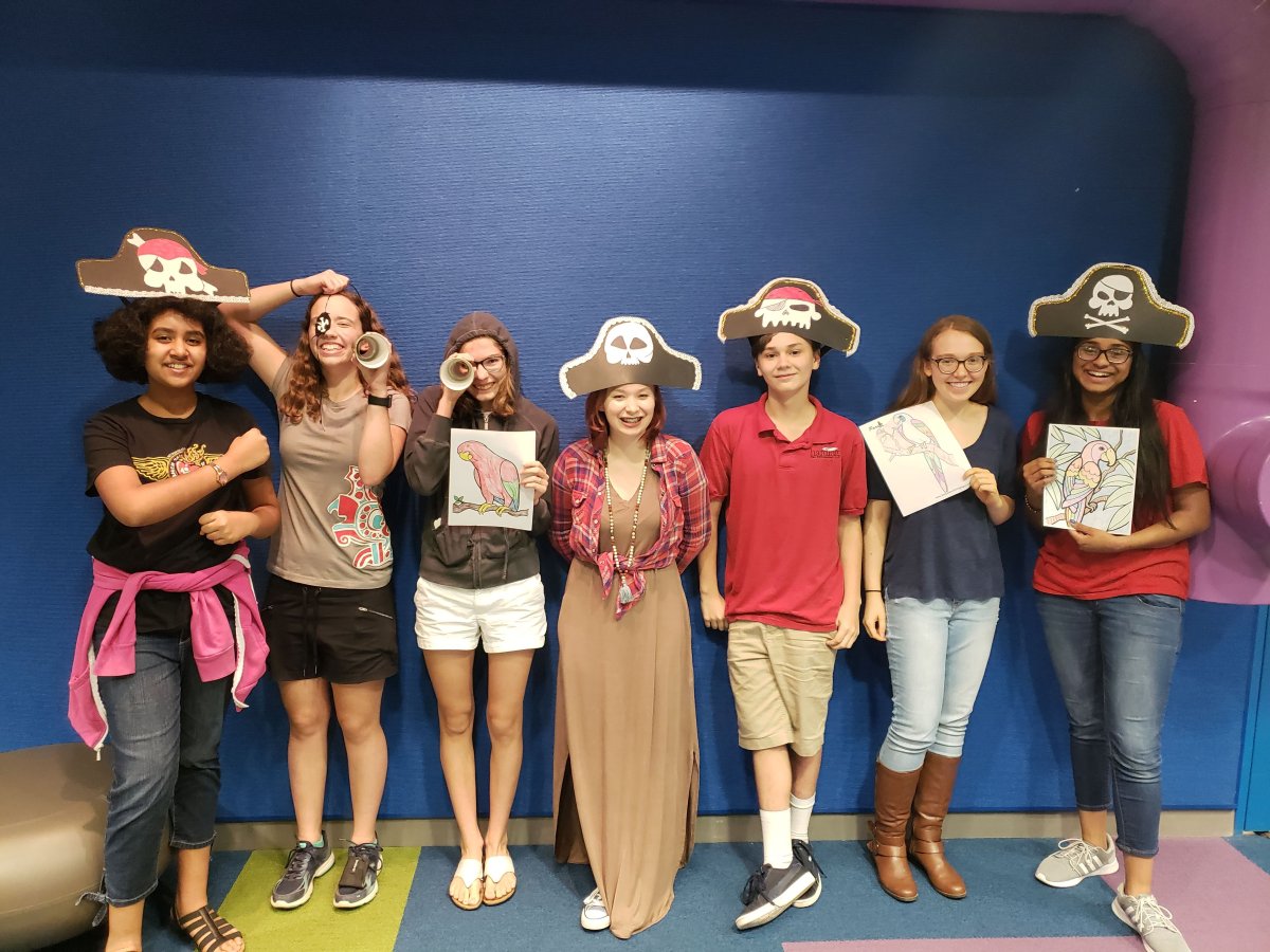 Teens showing off their pirate crafts