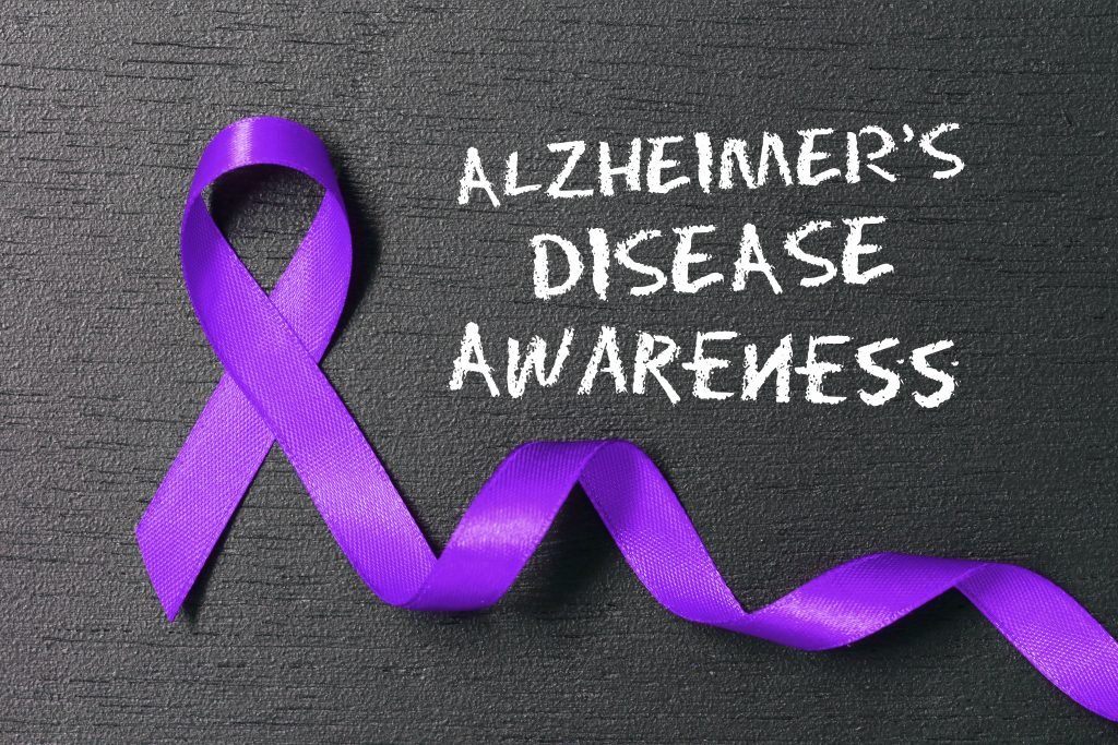 purple alzheimer's awareness ribbon on dark grey background