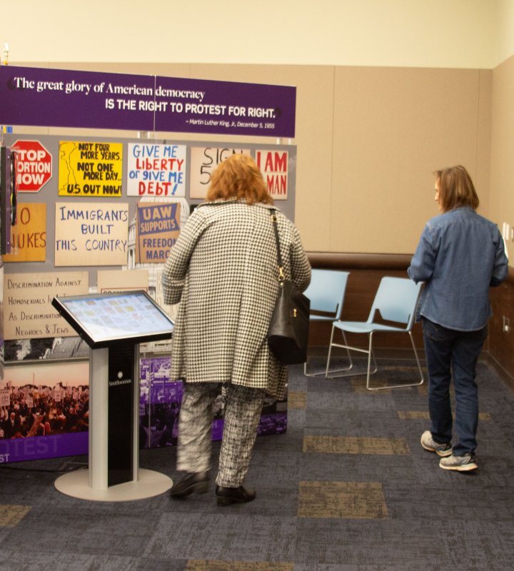 People walking through the Voices and Votes exhibit.